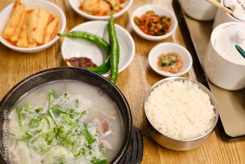 A clay pot of soondae gukbap (blood sausage soup) with steamed rice and assorted banchan, such as kimchi and green chilli peppers, at Yeodongsik - a Korean restaurant in Sydney, Australia  photo