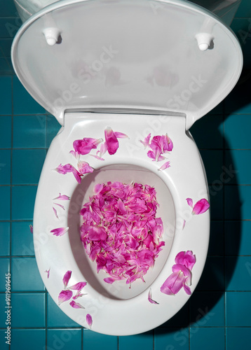 Magenta Pink Petals In A White Toilet Bowl On Blue Tiled Floor. 