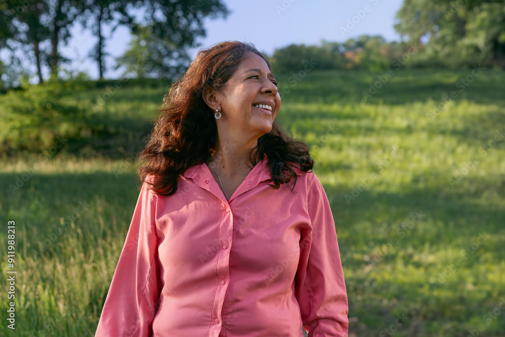 A portrait of a smiling woman enjoying the weather and nature A portrait of a smiling woman enjoying the weather and nature