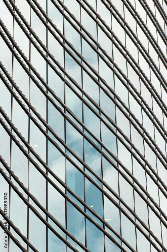 Curved glass facade on a skyscraper in the city of Tokyo, Japan Curved glass facade on a skyscraper in the city of Tokyo, Japan