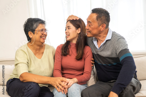 Portrait enjoy happy smiling love asian family.Senior mature father hug with elderly mother and young adult woman play laughing and having fun together at home.insurance concept