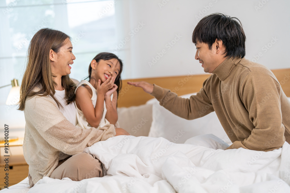 Portrait of enjoy happy love asian family father and mother holding hug cute little asian girl child smiling play and having fun moments good time, care, kid, support, insurance, child, at home Portrait of enjoy happy love asian family father and mother holding hug cute little asian girl child smiling play and having fun moments good time, care, kid, support, insurance, child, at home