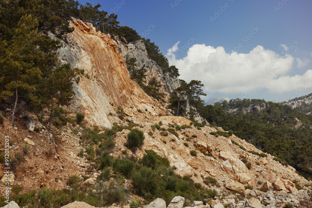 Mountainous Landslide in Forest Under Clear Blue Sky Mountainous Landslide in Forest Under Clear Blue Sky