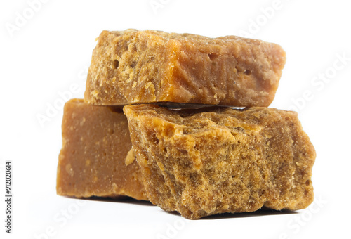 pieces of artisanal sugar cane panela on an isolated white background