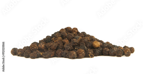 pile of black peppercorns isolated on a white background