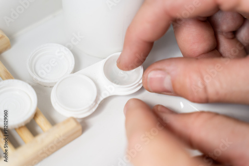 Man putting on contact lenses
