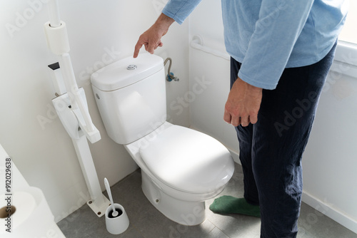 Man flushing toilet