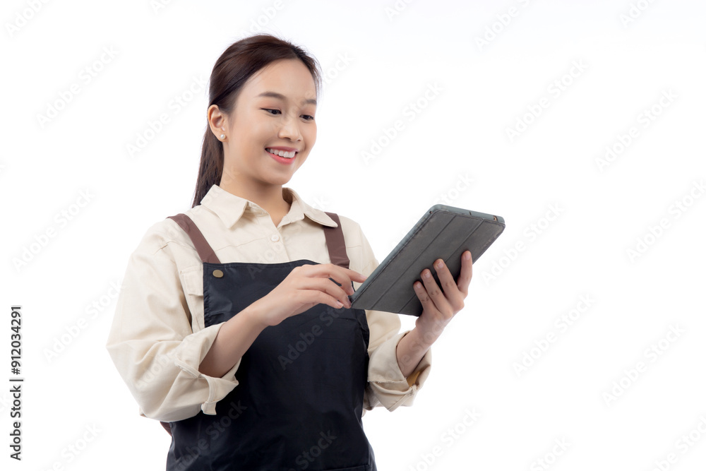 Portrait happy young asian barista woman in apron smiling while using digital tablet isolated white background, waitress or entrepreneur looking tablet, small business or startup, waiter of cafe. Portrait happy young asian barista woman in apron smiling while using digital tablet isolated white background, waitress or entrepreneur looking tablet, small business or startup, waiter of cafe.