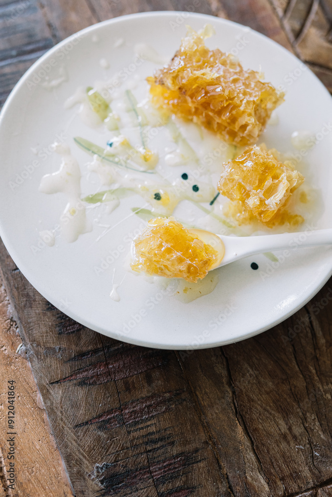 Aesthetic honeycomb pieces on plate, spoon natural Aesthetic honeycomb pieces on plate, spoon natural