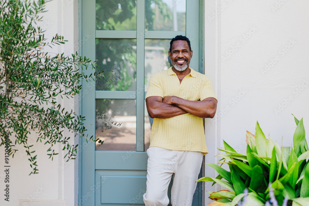 Man smiling with arms crossed at home Man smiling with arms crossed at home