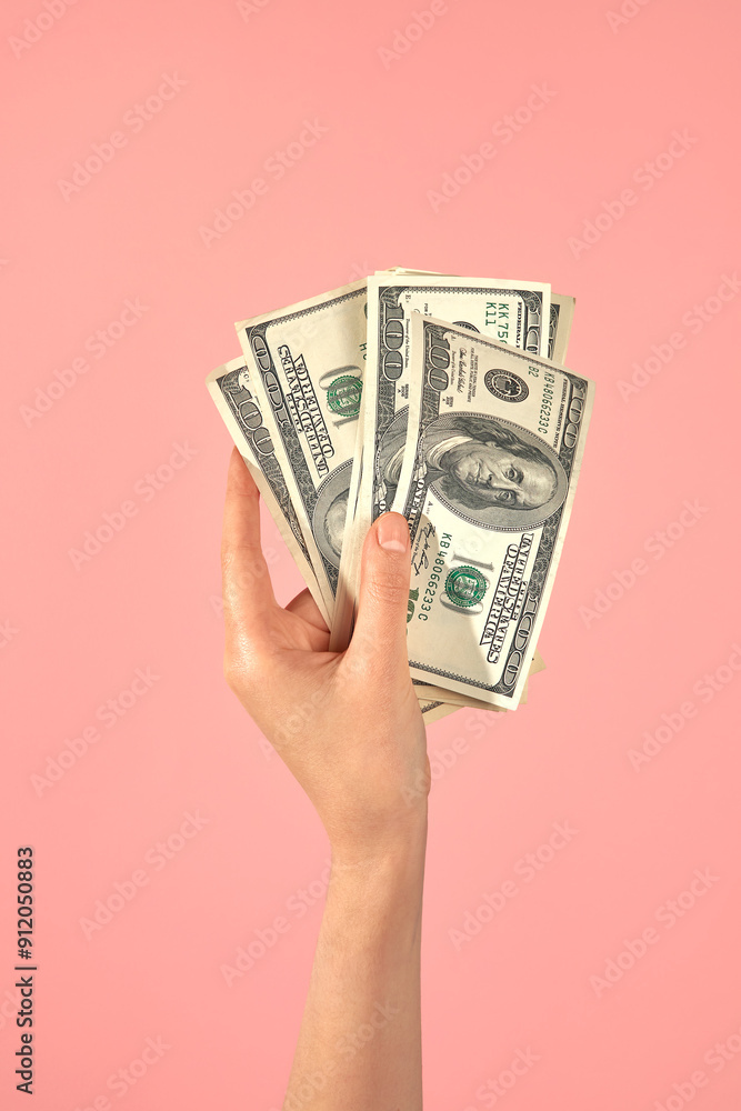Hand Holding US Dollar Bills Against Pink Background. Hand Holding US Dollar Bills Against Pink Background.