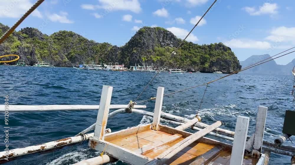Video from a boat sailing around Palawan in The Philippines. You can see boats and the tropical islands in the background. It's a sunny day with blue skies. Video from a boat sailing around Palawan in The Philippines. You can see boats and the tropical islands in the background. It's a sunny day with blue skies.