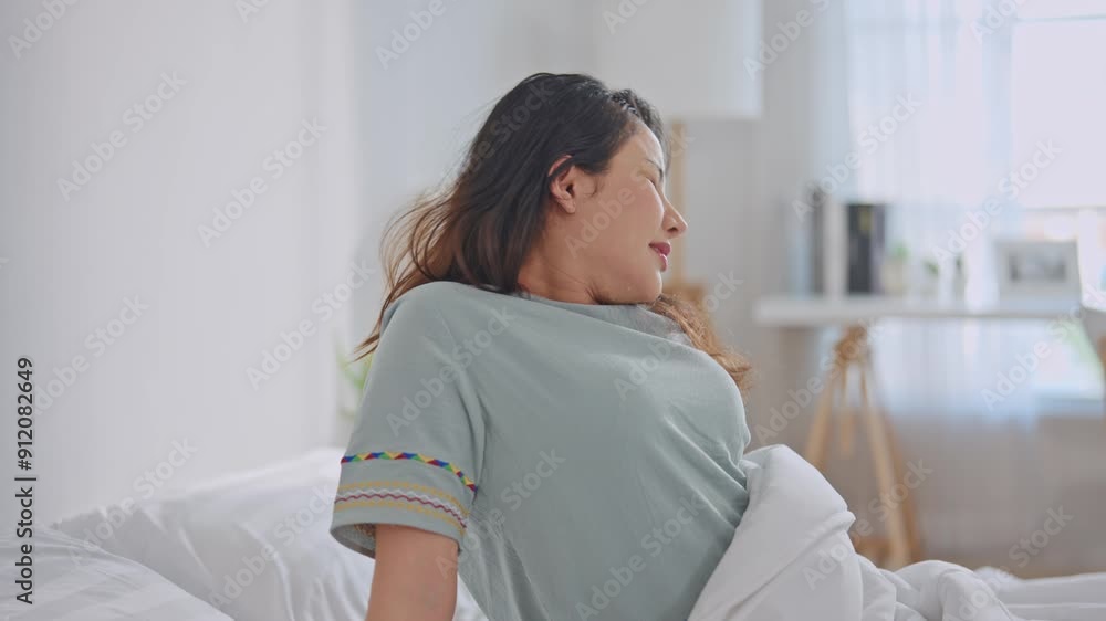 Asian beautiful girl in pajamas wake up in the morning with tired face. Asian beautiful girl in pajamas wake up in the morning with tired face.
