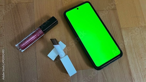 Smartphone and lipstick  photo