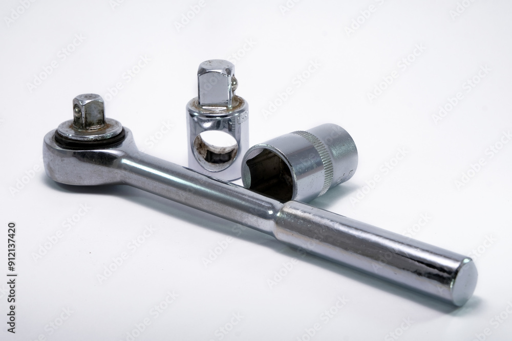 Torque wrench, work tool with rotatable ratchet on wooden background. Hand tool for tightening screws and nuts Torque wrench, work tool with rotatable ratchet on wooden background. Hand tool for tightening screws and nuts