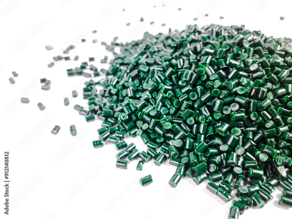 Forest green masterbatch granules on a white background. Color pigment carrier polymer in the plastics industry Forest green masterbatch granules on a white background. Color pigment carrier polymer in the plastics industry