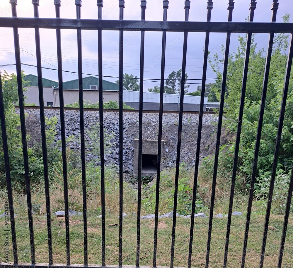 Storm drain behind fence at park Storm drain behind fence at park