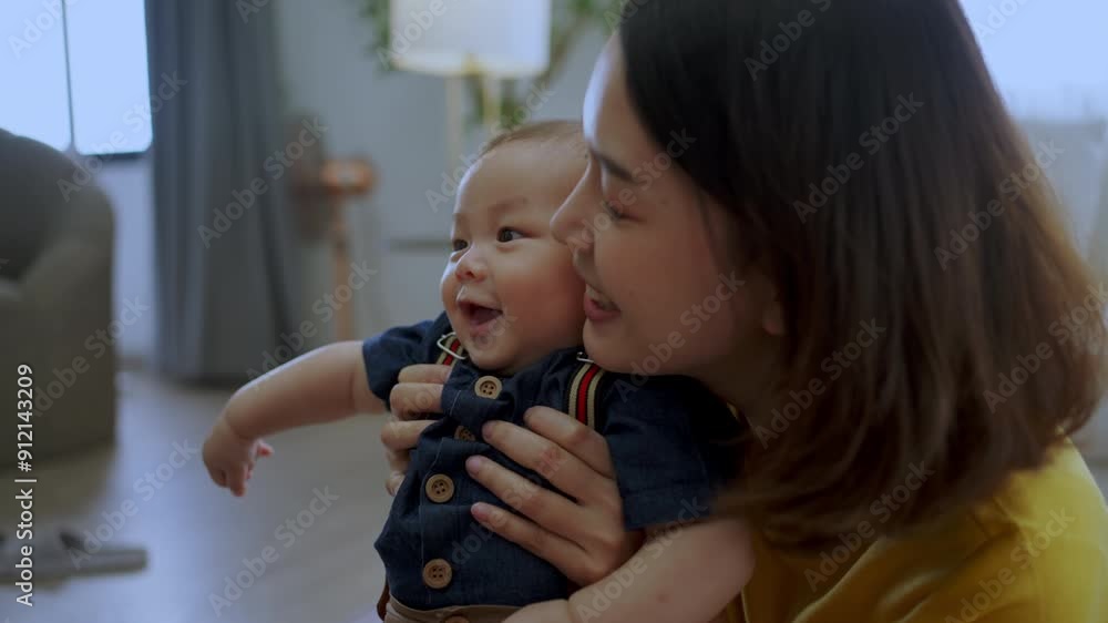 Asian baby playing with mom at house. Baby asian cheerful with family Asian baby playing with mom at house. Baby asian cheerful with family