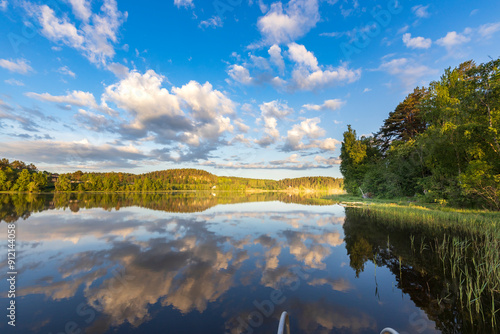 A lake with a cloudy sky in the background photo