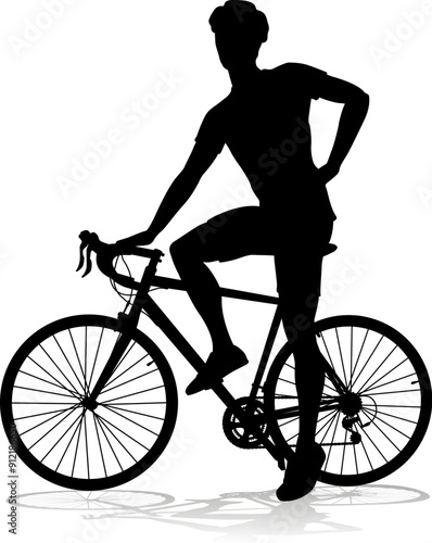 Bicyclist riding their bike and wearing a safety helmet in silhouette
