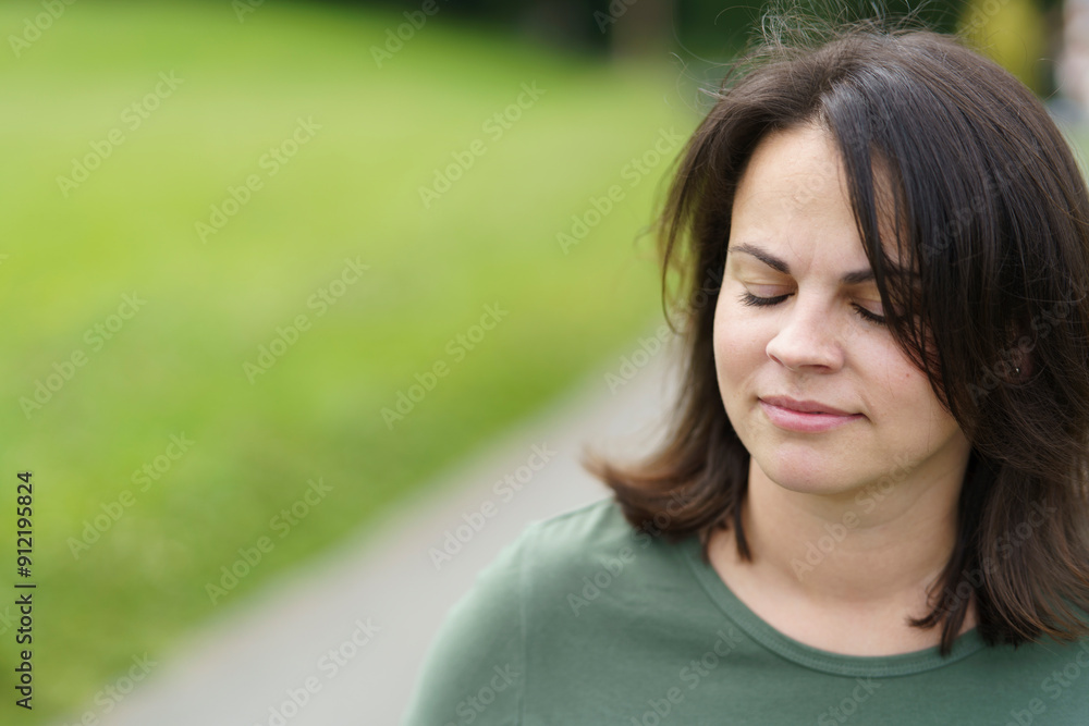 Beautiful smiling young woman on blurred natural background outdoors Beautiful smiling young woman on blurred natural background outdoors