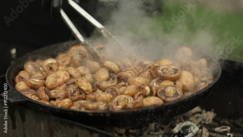 Frying mushrooms outdoors. Mushrooms are fried.