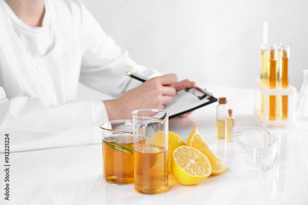 Aromatherapy product. Scientist developing essential oils at white table in laboratory, closeup Aromatherapy product. Scientist developing essential oils at white table in laboratory, closeup
