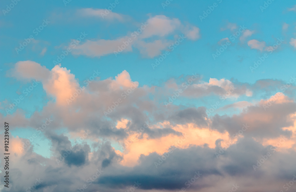 Fototapeta premium Dramatic clouds in the blue sky in the morning, the rising sun rays hitting the clouds