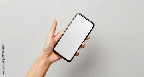 Hand Holding Smartphone with Blank Screen Against White Background