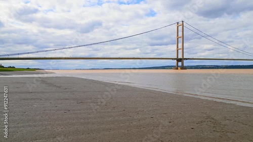 Aerial drone view of Humber Bridge, 12th largest suspension span, gracefully crossing River Humber, connecting Lincolnshire to Humberside with traffic.