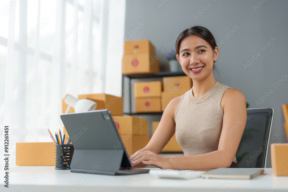 Obraz premium Start up small business entrepreneur SME or freelance asian woman using laptop with box, Young success Asian woman with her hand lift up , online marketing packaging box and delivery, SME concept.
