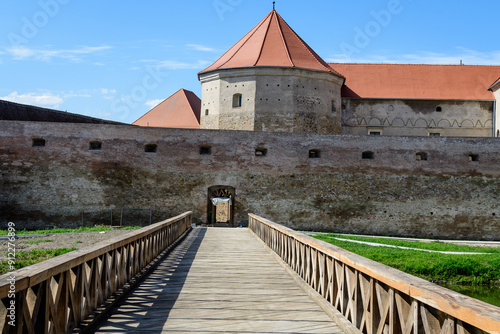 Renovated old historical buildings  of Fagaras Fortress (Cetatea Fagaras) during renovation works in a sunny summer day, in Transylvania (Transilvania) region, Romania  . photo