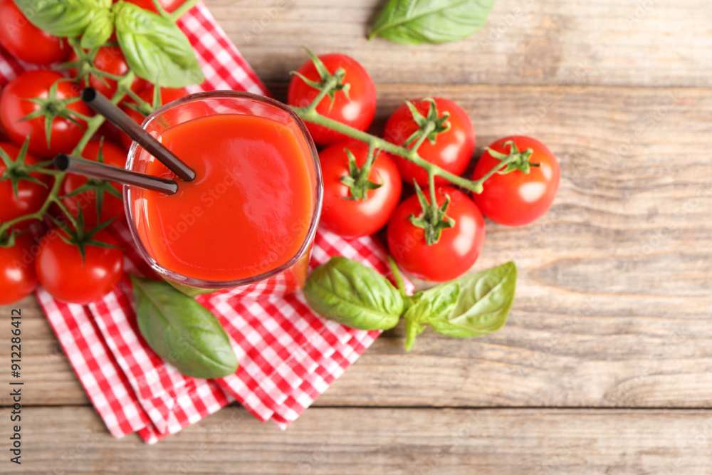 Tasty tomato juice in glass with fresh vegetables and basil on wooden table, flat lay. Space for text Tasty tomato juice in glass with fresh vegetables and basil on wooden table, flat lay. Space for text