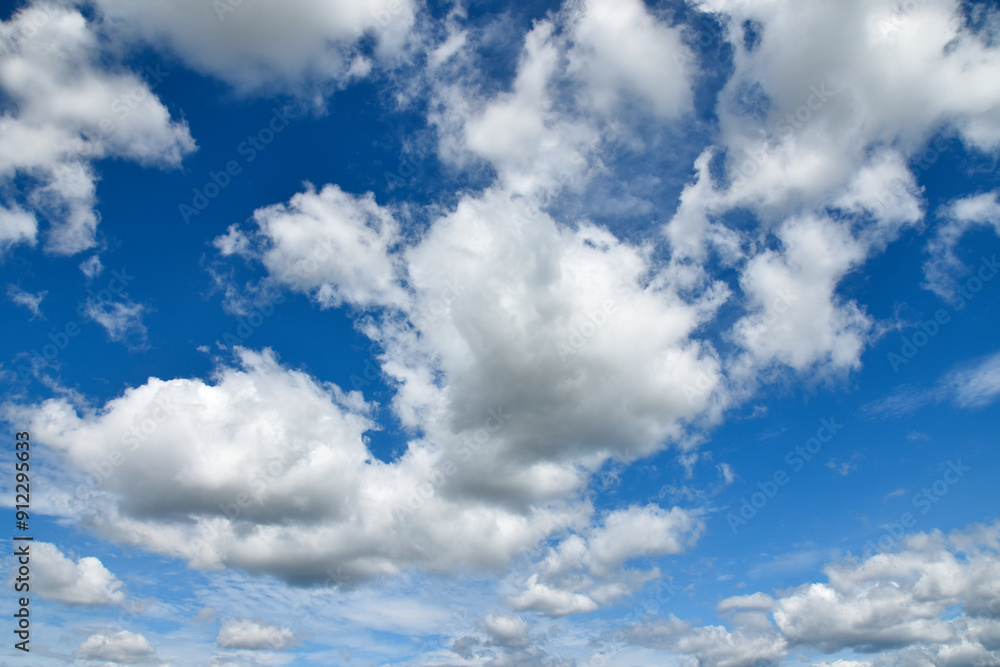 White clouds in the sky on a sunny day White clouds in the sky on a sunny day