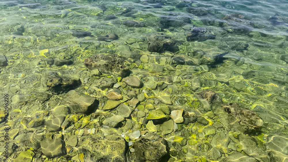 Adriatic sea surface with pebbles and stones Adriatic sea surface with pebbles and stones
