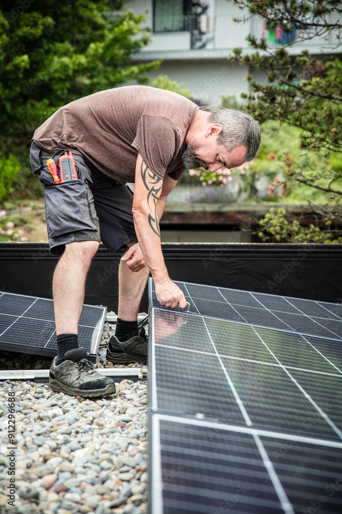 a male craftsman or electrician installs solar modules a male craftsman or electrician installs solar modules
