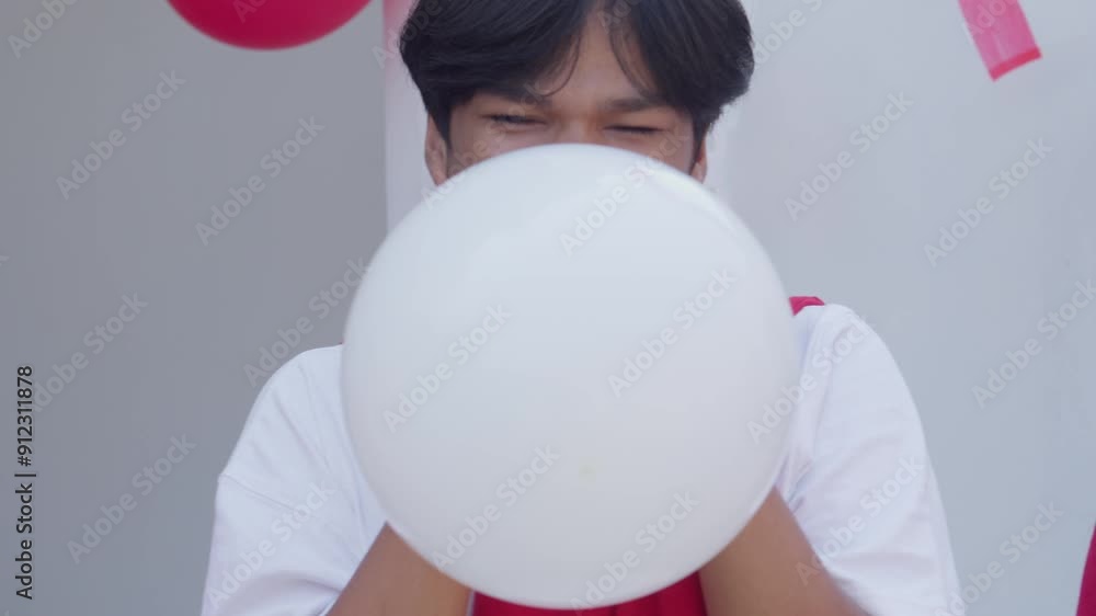 Happy Young Asian Friends Blowing Balloon Together On Indonesian Independence Day Competition Happy Young Asian Friends Blowing Balloon Together On Indonesian Independence Day Competition