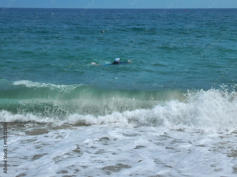 A child is drowning in the ocean with strong waves. A child is drowning in the ocean with strong waves.