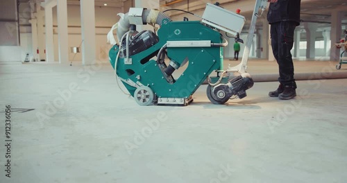 Floor Preparation by Shot Blasting. Worker preparing the surface for the application of new coatings. photo