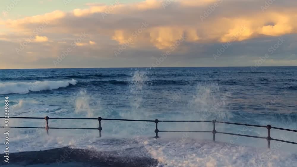 Footage shows beautiful waves and clouds at a pier or a harbor with ...
