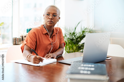 African woman, headphones and writing in office with notebook, planning and inspiration at company. Person, thinking and insight for ideas, solution or problem solving with music at creative agency