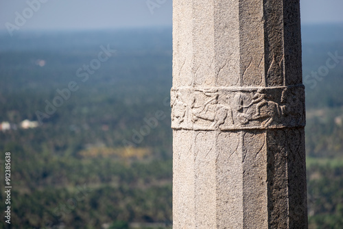 Intricate detail of carvings on a granite pillar at an ancient temple in Shravanabelagola. photo