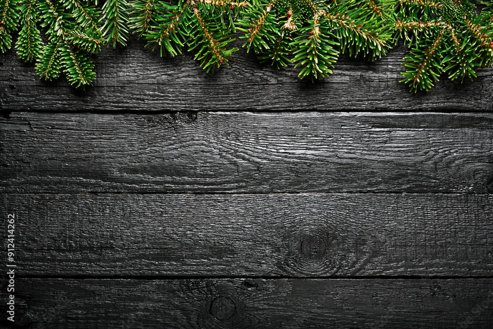 Christmas background with fir tree on black wooden table Christmas background with fir tree on black wooden table