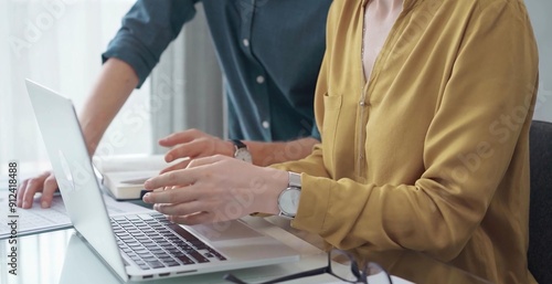 Team collaboration over financial reports. Business people, professionals analyzing financial charts and data on a desk while sitting near a laptop computer