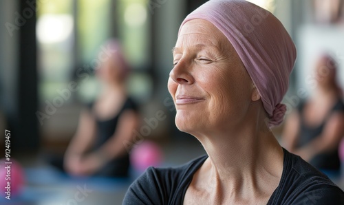 close-up portrait of an elderly cancer survivor with a pink headscarf, smiling during a yoga class in the gym, focusing on relaxation techniques for coping