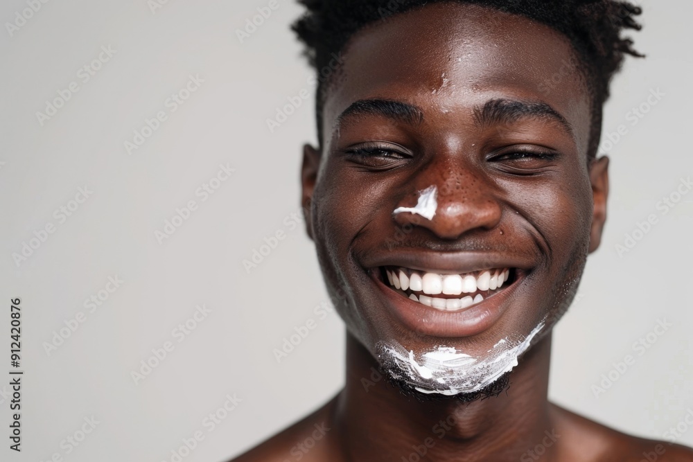 A young African American man with a facial mask, smiling and looking directly at the camera A young African American man with a facial mask, smiling and looking directly at the camera