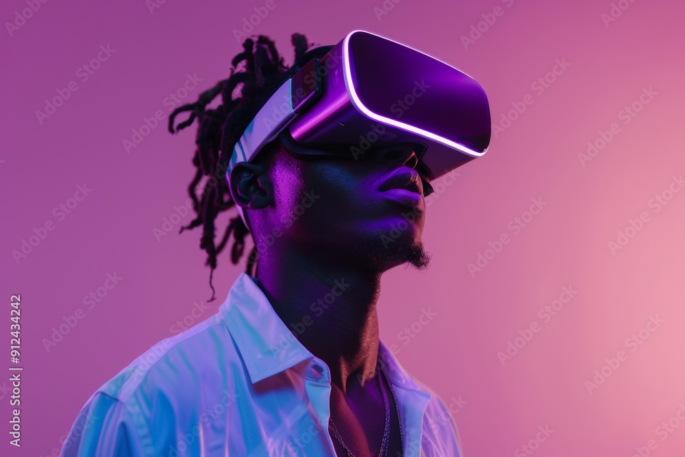 Man with afro wearing VR headset against pink background. Man with afro wearing VR headset against pink background.