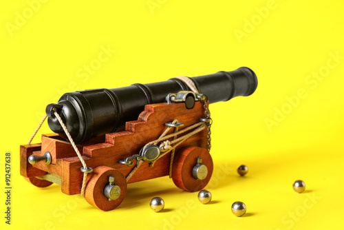 Toy model of cannon on yellow background