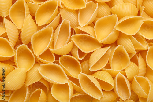 Raw conchiglie pasta as background photo