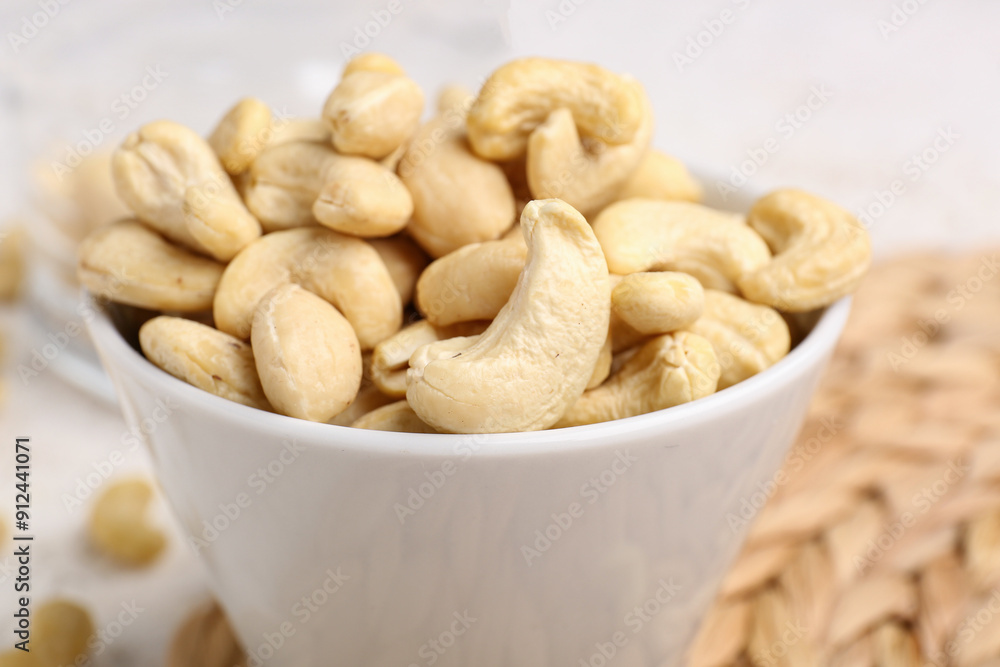 Bowl with tasty cashew nuts on table, closeup Bowl with tasty cashew nuts on table, closeup